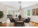 Dining area open to the living room, features hardwood floors, and modern lighting at 1910 Thompson Ave, East Point, GA 30344