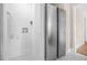 Hallway featuring a stainless steel refrigerator and access to the laundry room and bathroom at 1910 Thompson Ave, East Point, GA 30344