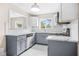 Newly renovated kitchen featuring sleek gray cabinets, granite countertops, and stainless steel appliances at 1910 Thompson Ave, East Point, GA 30344