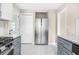 Modern kitchen with stainless steel refrigerator and gas range stove and white cabinets at 1910 Thompson Ave, East Point, GA 30344