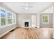 Sunlit living room with wood floors and fireplace, offering a cozy atmosphere at 1910 Thompson Ave, East Point, GA 30344