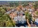 Overhead view of condo community surrounded by mature trees, parking, and neighborhood streets at 303 Gettysburg Pl, Atlanta, GA 30350