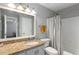 Bathroom featuring granite countertop and shower with decorative tile surround at 303 Gettysburg Pl, Atlanta, GA 30350