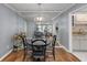 Dining area with hardwood floors, decorative mirror, and stylish light fixture at 303 Gettysburg Pl, Atlanta, GA 30350