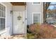 Charming home exterior with a decorative front door and well-maintained landscaping at 303 Gettysburg Pl, Atlanta, GA 30350
