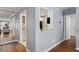 Hallway featuring hardwood floors and views into the kitchen and living room at 303 Gettysburg Pl, Atlanta, GA 30350