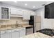 Modern kitchen features stainless steel appliances, granite countertops, and white cabinetry at 303 Gettysburg Pl, Atlanta, GA 30350