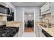 Updated kitchen with stainless steel appliances, granite countertops and white tiled floors at 303 Gettysburg Pl, Atlanta, GA 30350