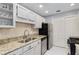 Well-lit kitchen boasts stainless steel appliances, granite countertops, and ample storage space at 303 Gettysburg Pl, Atlanta, GA 30350