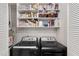 Laundry room with washer, dryer, and ample storage space at 303 Gettysburg Pl, Atlanta, GA 30350