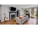 Inviting living room features a fireplace, large windows, and hardwood floors for a warm and bright space at 303 Gettysburg Pl, Atlanta, GA 30350