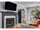 Comfortable living room with a decorative fireplace, large windows, and stylish décor at 303 Gettysburg Pl, Atlanta, GA 30350