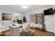 Bright office space featuring a modern white desk, stylish shelves, and a wall-mounted television at 303 Gettysburg Pl, Atlanta, GA 30350