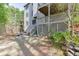 Spacious backyard with a multilevel deck and stone retaining wall features lush landscaping and privacy at 4880 Stone Moss Path, Hoschton, GA 30548