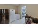 Functional basement area with a fridge, freezer, and organized storage space at 4880 Stone Moss Path, Hoschton, GA 30548