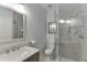 Modern bathroom featuring glass shower, gray tile, and decorative mirror above the marble vanity top at 4880 Stone Moss Path, Hoschton, GA 30548