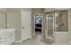 Well-lit bathroom with shower and vanity, neutral walls, and tiled floors at 4880 Stone Moss Path, Hoschton, GA 30548