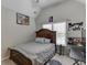 Bedroom featuring a bed with a wooden headboard, artwork, and a ceiling fan at 4880 Stone Moss Path, Hoschton, GA 30548