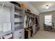 Walk-in closet with custom shelving, drawers, and ample hanging space for organized storage at 4880 Stone Moss Path, Hoschton, GA 30548