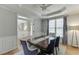 Bright dining room enhanced by large windows and wainscoting at 4880 Stone Moss Path, Hoschton, GA 30548