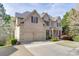 Stately two-story brick home with a two-car garage, lush landscaping, and a well-maintained lawn at 4880 Stone Moss Path, Hoschton, GA 30548