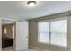 Bright hallway leads into the living room and features neutral walls and carpet and bright window at 4880 Stone Moss Path, Hoschton, GA 30548