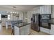 Spacious kitchen with a central island, stainless steel appliances, and modern cabinetry with adjoining dining area at 4880 Stone Moss Path, Hoschton, GA 30548