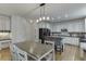 Eat-in kitchen with granite countertops, stainless steel appliances, and custom cabinetry at 4880 Stone Moss Path, Hoschton, GA 30548