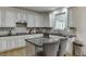 Gourmet kitchen featuring granite countertops, stainless steel appliances, and ample cabinet space at 4880 Stone Moss Path, Hoschton, GA 30548