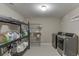 Functional laundry room features modern washer and dryer, shelving, and ample storage at 4880 Stone Moss Path, Hoschton, GA 30548
