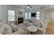 Inviting living room featuring hardwood floors, fireplace, and built-in shelving at 4880 Stone Moss Path, Hoschton, GA 30548