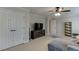 Open living area featuring stylish gray sofa, modern media center, and bright natural light at 4880 Stone Moss Path, Hoschton, GA 30548