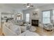 Bright living room with hardwood floors, fireplace, arched entryway, and neutral decor at 4880 Stone Moss Path, Hoschton, GA 30548