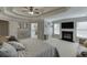 Bright primary bedroom featuring fireplace, sitting area, and tray ceiling at 4880 Stone Moss Path, Hoschton, GA 30548