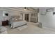 Luxurious primary bedroom with tray ceiling, a decorative bed, and ample space at 4880 Stone Moss Path, Hoschton, GA 30548