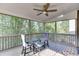 Relaxing screened porch features a ceiling fan and comfortable seating at 4880 Stone Moss Path, Hoschton, GA 30548