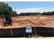 An available vacant lot showcases construction potential against a backdrop of trees and open sky at 6343 Towhee Way, Morrow, GA 30260