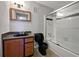 Compact bathroom features a dark vanity, toilet, and a tub-shower combo at 4640 Vinings Central Se Run # 128, Atlanta, GA 30339