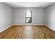 The bedroom has wood-look flooring, a window, and neutral walls at 4640 Vinings Central Se Run # 128, Atlanta, GA 30339