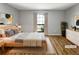 This light-filled bedroom features wood floors, a large window, and neutral décor at 4640 Vinings Central Se Run # 128, Atlanta, GA 30339