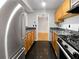 Galley kitchen with stainless steel appliances, oak cabinets, and black countertops at 4640 Vinings Central Se Run # 128, Atlanta, GA 30339
