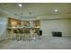 Finished basement bar area with seating and cabinetry at 4777 Ardmore Ln, Hoschton, GA 30548