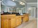Bathroom featuring double vanity with granite countertop and a soaking tub in the background at 4777 Ardmore Ln, Hoschton, GA 30548