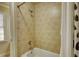 Clean bathroom featuring tile walls, a bathtub with shower, and a window at 4777 Ardmore Ln, Hoschton, GA 30548
