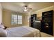 Comfortable bedroom featuring a ceiling fan, neutral colors, and natural light from a window at 4777 Ardmore Ln, Hoschton, GA 30548