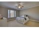 Neutral bedroom featuring a ceiling fan, and a large window providing natural light at 4777 Ardmore Ln, Hoschton, GA 30548