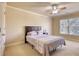 Cozy bedroom featuring soft carpet, a ceiling fan, and natural light from the window at 4777 Ardmore Ln, Hoschton, GA 30548