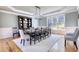 Spacious dining room with a large table and chairs, a decorative hutch, and natural light from the windows at 4777 Ardmore Ln, Hoschton, GA 30548
