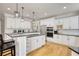 Bright and modern kitchen with white cabinetry, stainless steel appliances, and a functional island with seating at 4777 Ardmore Ln, Hoschton, GA 30548