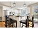 Modern kitchen with white cabinets, a center island, stainless steel appliances, and stylish pendant lighting at 4777 Ardmore Ln, Hoschton, GA 30548